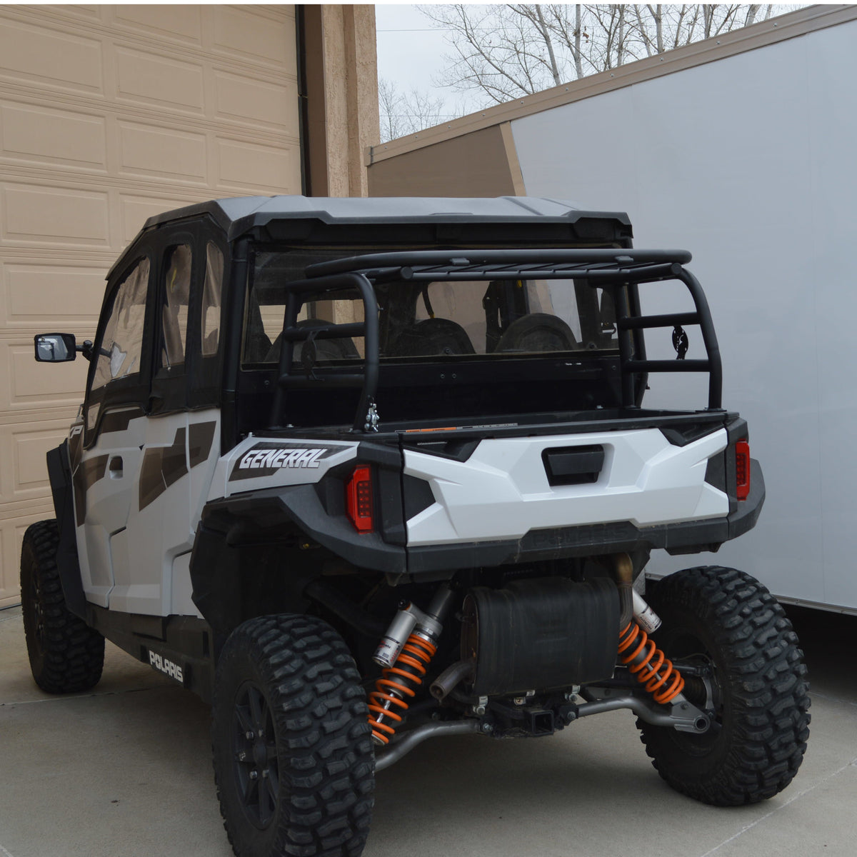 Spare tire carried on the Polaris General cargo rack, below the roofline