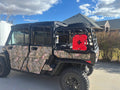 Matte black steel cargo rack with tailgate mounted on a Can-Am Defender bed
