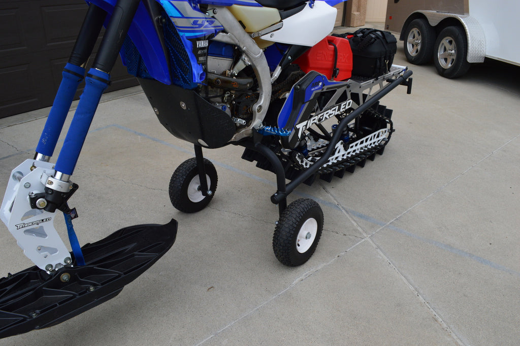 Snow bike dolly that protects the track from pavement and shop floors